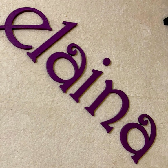 Wooden letters spell ELIANA ELAINA or ELI & ANA